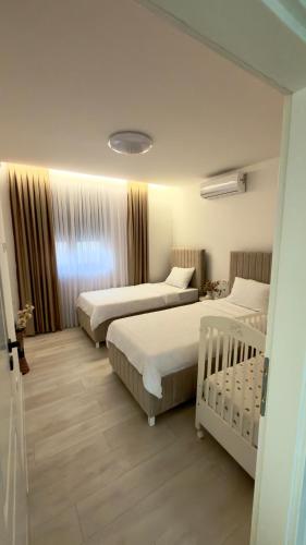 a hotel room with two beds and a window at Villa Maja in Blagaj