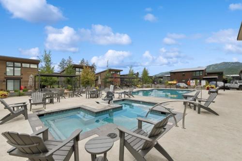 a pool with chairs and tables and a resort at Quarry A35 in Whitefish