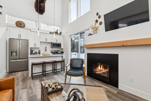 a kitchen and living room with a fireplace at Quarry A35 in Whitefish