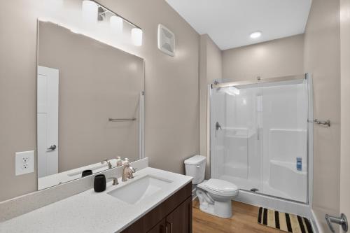 a bathroom with a sink and a shower and a toilet at Parkview Greer 2BR Getaway in Greer