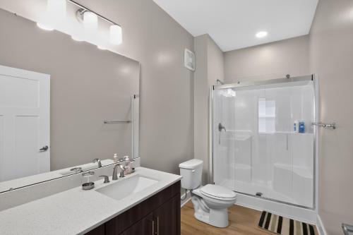 a white bathroom with a shower and a toilet at Homey 2BR with Great Space in Greer