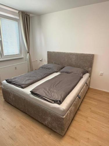 a large bed in a room with at Stylish New Apartment with Parking Place in Bratislava