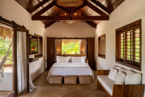 a bedroom with a large white bed and a window at Villa Alegria - La Villa Group in Jericoacoara