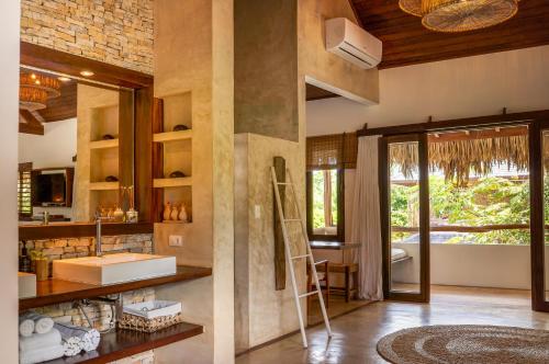 a bathroom with a sink and a mirror at Villa Alegria - La Villa Group in Jericoacoara