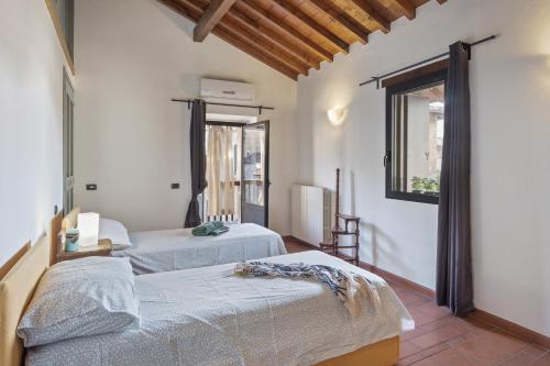 a bedroom with two beds and a window at I Balconi in Iseo