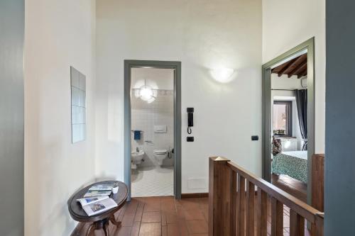 a hallway with a bathroom with a toilet and a staircase at I Balconi in Iseo