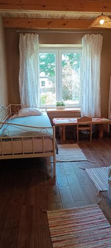 a bedroom with a bed and a large window at Agroturystyka Stasin in Trojanów