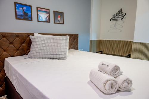 a bedroom with a bed with towels on it at URB Hotel in Fortaleza