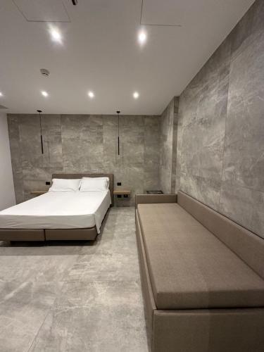 a bedroom with a large bed and a couch at Hotel Corona in Termoli