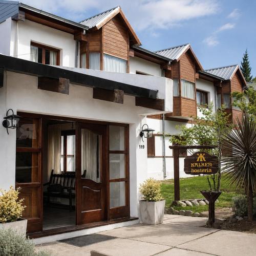 a house with a door and a sign in front of it at Kalken Hotel by MH in El Calafate