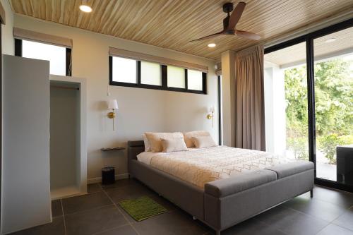 a bedroom with a bed and a ceiling fan at Ocean View Villa at Solindo Stays in Marbella