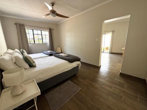 a bedroom with a bed and a ceiling fan at Family Garden Suite - Sleeps 4 in Pretoria
