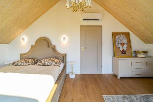 a bedroom with a bed and a dresser in a attic at Velur Haus in Borne Sulinowo