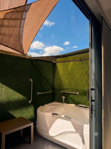 a bathroom with a large window and a tub at Laureles Premium Loft con Jacuzzi Privado in Medellín