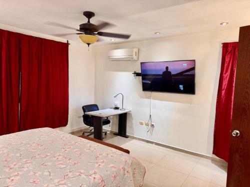 a bedroom with a bed and a tv on the wall at Victory House Mty in Monterrey