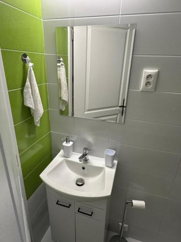 a bathroom with a sink and a mirror at Chata pod hradom in Divín