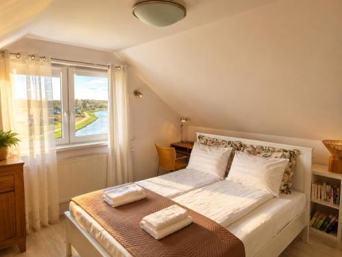 a bedroom with a large bed with a window at Widokówka in Tarnobrzeg