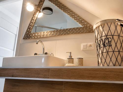 a bathroom with a sink and a mirror at Widokówka in Tarnobrzeg