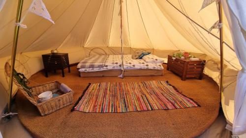 a room with a tent with a bed and a table at Skipbridge farm glamping in York