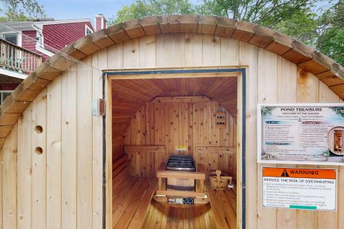 a large wooden building with an open door at Pond Treasure in Sandwich