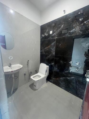 a bathroom with a toilet and a sink at The Seven Suites - Fort View in Chittaurgarh
