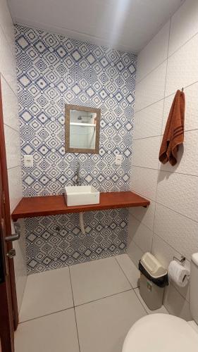 a bathroom with a sink and a toilet at Pousada Bouganvile Atins in Atins
