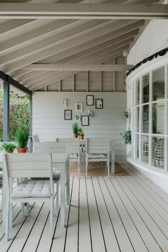 a patio with a table and chairs on a porch at The Beach House in West Wittering