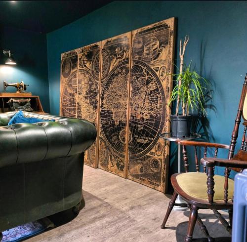 a living room with a map on the wall at The Wolf's Den in Patrington
