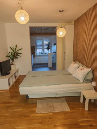 a bedroom with a large bed and two lights at Apartma 198 in Kranjska Gora