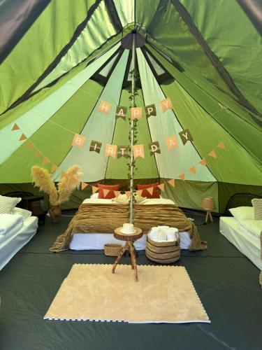 a large green tent with two beds in it at Debed Glamping in Debed