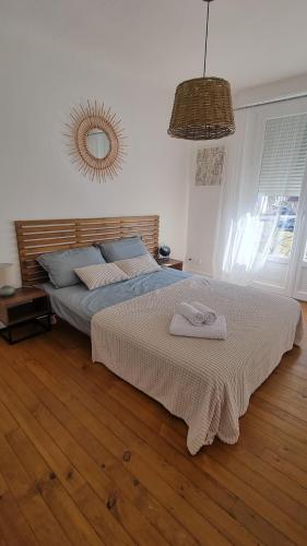 a bedroom with a bed with a towel on it at Chez Gabin in Tartas