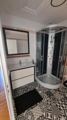 a bathroom with a tub and a sink and a shower at Chez Gabin in Tartas