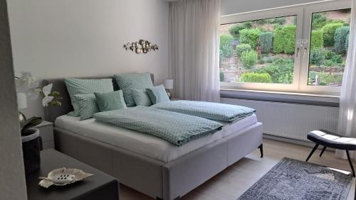 a bedroom with a bed and a large window at Arwilere in Bad Neuenahr-Ahrweiler