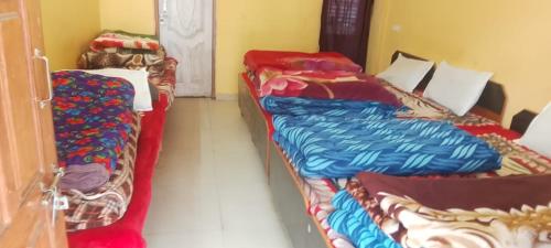 two beds are sitting in a room at Glacier view point kedarnath in Kedārnāth