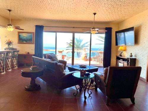 a living room with a view of the ocean at Ocean Front Baja Vacation in Rosarito