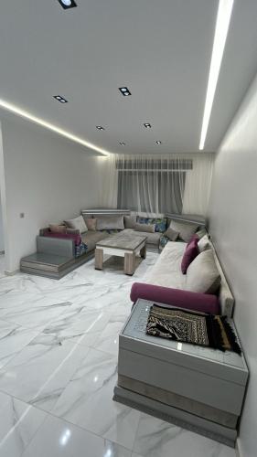 a living room with a bed and a table at Oumaira Residence Azla-Tetouan in Azla