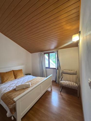 a bedroom with a bed and a wooden ceiling at Maurícius Village in Santa Cruz