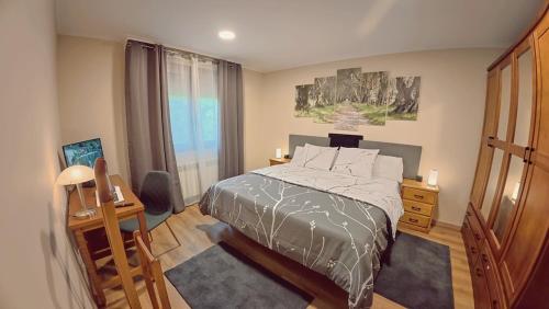 a bedroom with a bed and a large window at A Casa de Moire in Arnois