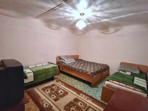 a room with two beds and a ceiling at Valentina`s Guesthouse in Korumdy