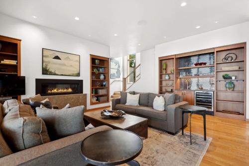 a living room with two couches and a fireplace at Rivers End Lake House in Bigfork
