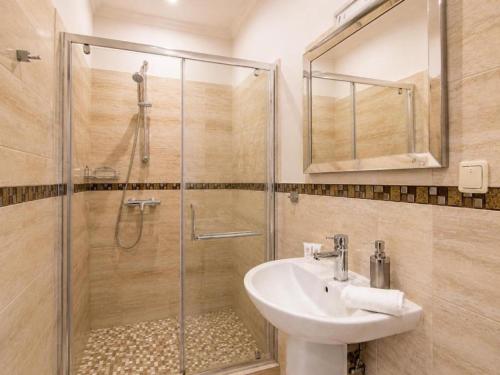 a bathroom with a sink and a shower at Nika Apart hotel in Riga