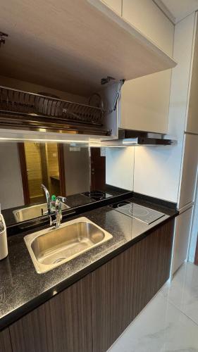a kitchen with a sink and a stove at Panbil Residence Apartment - Studio 2 Bed in Bagam