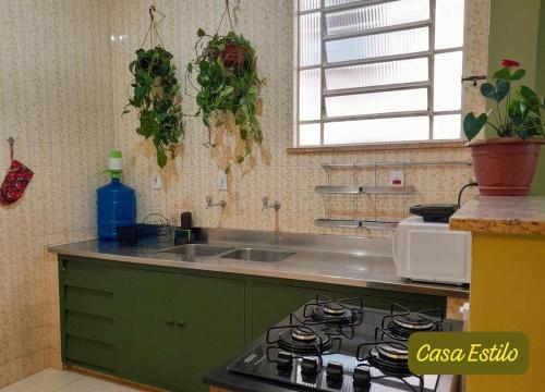 a kitchen with a stove top and a sink at Casa Estilo - São Lourenço in São Lourenço