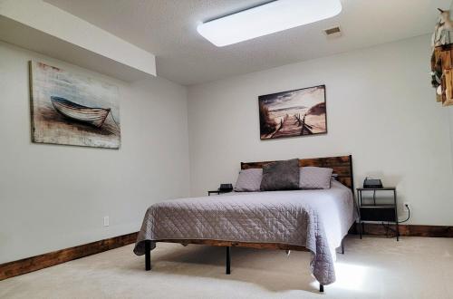 a bedroom with a bed and two pictures on the wall at Dakota Lodge in Dickinson