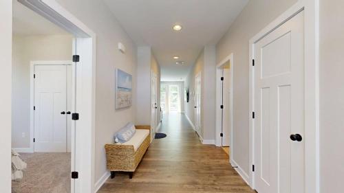 a hallway of a home with white walls and a couch at Bethany Woods - 31600 Charleys Run in Bethany Beach