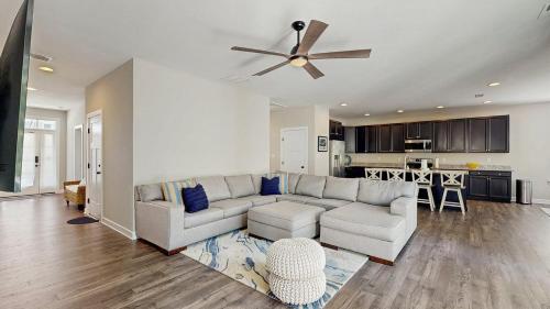 a living room with a couch and a ceiling fan at Bethany Woods - 31600 Charleys Run in Bethany Beach