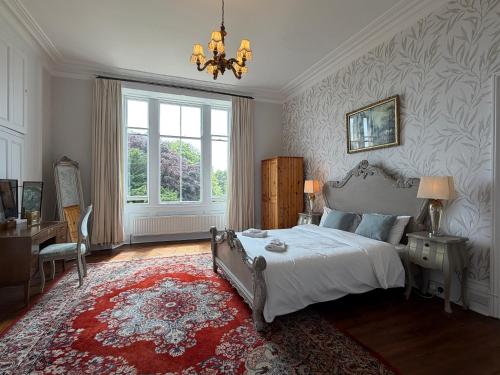 a bedroom with a bed and a desk and a window at Kirkland in Berwick-Upon-Tweed