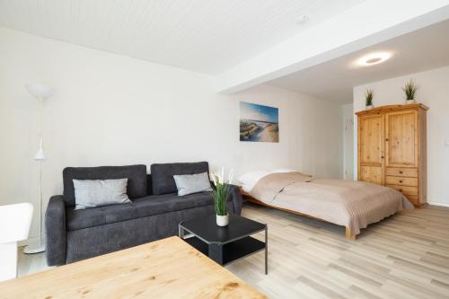 a living room with a couch and a bed at Fördeperle Laboe in Laboe