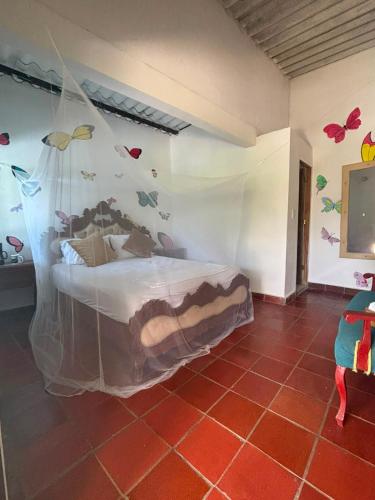 a bedroom with a bed with butterflies on the wall at Casa chill out in Minca