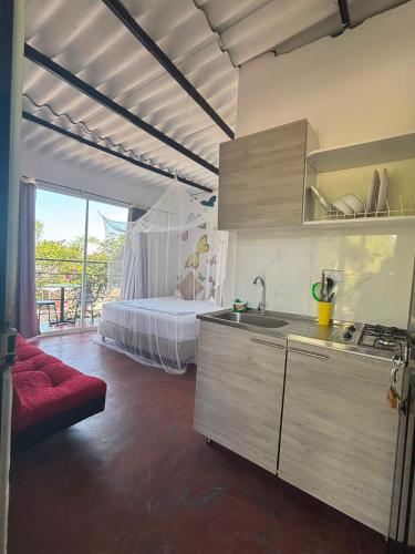 a kitchen with a sink and a bed in a room at Casa chill out in Minca